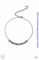 Dainty gunmetal rings swing from a dainty gunmetal chain, creating a flirtatious fringe. Features an adjustable clasp closure. Sold as one individual choker necklace. Includes one pair of matching earrings.  P2CH-BKXX-053XX