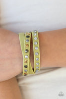 A skinny strip of green leather is encrusted in sections of glittery white rhinestones and flat gold, gunmetal, and silver studs. The elongated band double wraps around the wrist for a fierce one-of-a-kind look. Features an adjustable snap closure. Sold as one individual bracelet.  P9DI-URGR-035XX