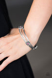 Embossed in tribal inspired patterns, two dainty silver bangles join a glistening silver bangle dotted in ornate silver frames. Glittery pink rhinestones dot the centers of the frilly frame, adding a refined sparkle to the layered palette. Sold as one set of three bracelets.  P9RE-PKXX-103XX