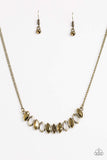 Featuring regal marquise style shapes, shimmery brass frames join below the collar. The sparkling pendant features mismatched aurum rhinestone accents for a refined finish. Features an adjustable clasp closure. Sold as one individual necklace. Includes one pair of matching earrings.   P2RE-BRXX-112VU