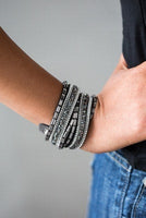 Varying in cut and shimmer, smoky, hematite, and white rhinestones are sprinkled along gray suede bands for a sassy look. The elongated design allows for a trendy double wrap around the wrist. Features an adjustable snap closure.  P9DI-URSV-070XX