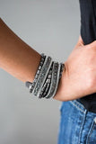 Varying in cut and shimmer, smoky, hematite, and white rhinestones are sprinkled along gray suede bands for a sassy look. The elongated design allows for a trendy double wrap around the wrist. Features an adjustable snap closure.  P9DI-URSV-070XX