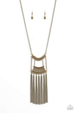 Encrusted in glittery aurum rhinestones, a bowing brass pendant attaches to an ornate brass frame, creating a bold pendant. Infused with an elongated brass chain, the tribal inspired pendant gives way to a shimmery brass fringe for a fierce finish. Features an adjustable clasp closure. Sold as one individual necklace. Includes one pair of matching earrings.  P2TR-BRXX-066XX