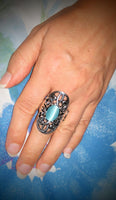 2020 July Fashion Fix Exclusive A glowing blue cat’s eye stone is pressed into the center of an oval backdrop swirling with vine-like filigree for a whimsical look. Features a stretchy band for a flexible fit. Sold as one individual ring.  P4WH-BLXX-159XX