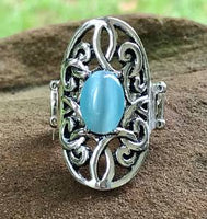 2020 July Fashion Fix Exclusive A glowing blue cat’s eye stone is pressed into the center of an oval backdrop swirling with vine-like filigree for a whimsical look. Features a stretchy band for a flexible fit. Sold as one individual ring.  P4WH-BLXX-159XX