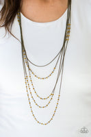Brushed in a metallic shimmer, dainty aurum beads trickle along brass chains, creating shimmery layers across the chest. Featuring faceted edges, the glittery beads cascade down the sides of the palette for an additional hint of sparkle. Features an adjustable clasp closure. Sold as one individual necklace. Includes one pair of matching earrings.   P2RE-BRXX-110XX