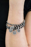 Dainty black and silver beads are threaded along stretchy elastic bands, creating colorful layers across the wrist. Brushed in an antiqued shimmer, ornate silver charms swing from the wrist for a wanderlust finish. Sold as one set of four bracelets.  P9TR-BKXX-034XX