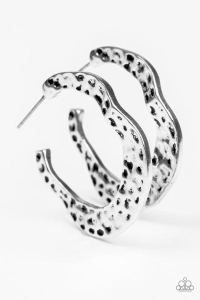 Delicately hammered in shimmery textures, a glistening ribbon of silver curls into an edgy, asymmetrical hoop. Earring attaches to a standard post fitting. Hoop measures 1” in diameter. Sold as one pair of hoop earrings.  P5HO-SVXX-111XX