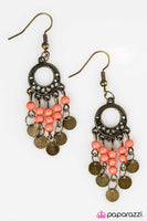 Dainty orange beading trickles from the bottom of an ornate frame, creating a colorful fringe. Brushed in an antique finish, brazen brass discs swing from the bottom of the beaded trestles for a bohemian inspired finish. Earring attaches to a standard fishhook fitting. Sold as one pair of earrings.   P5SE-OGXX-051XX