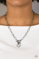 Encrusted in glassy white rhinestones, a dainty gunmetal heart swings from the bottom of a glistening gunmetal chain for a classic look. Features a toggle closure. Sold as one individual necklace. Includes one pair of matching earrings.  P2WH-BKXX-242XX