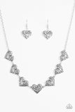 Featuring filigree-filled centers, glistening silver heart frames connect below the collar in a romantic fashion. Features an adjustable clasp closure. Sold as one individual necklace. Includes one pair of matching earrings.   P2WH-SVXX-224VH