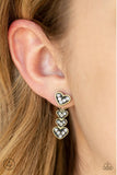 A white rhinestone encrusted brass heart attaches to a double-sided post, designed to fasten behind the ear. Stacked in gradually increasing white rhinestone encrusted heart frames, the glittery double-sided post peeks out beneath the ear for a charming look. Earring attaches to a standard post fitting. Sold as one pair of post earrings.  P5PO-BRXX-031XX