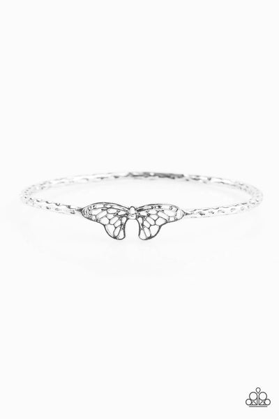 Delicately hammered in shimmery textures, an antiqued silver bangle joins around the wrist. Featuring life-like patterns, an airy butterfly charm attaches to the bangle, creating a whimsical centerpiece. P9WH-SVXX-130XX