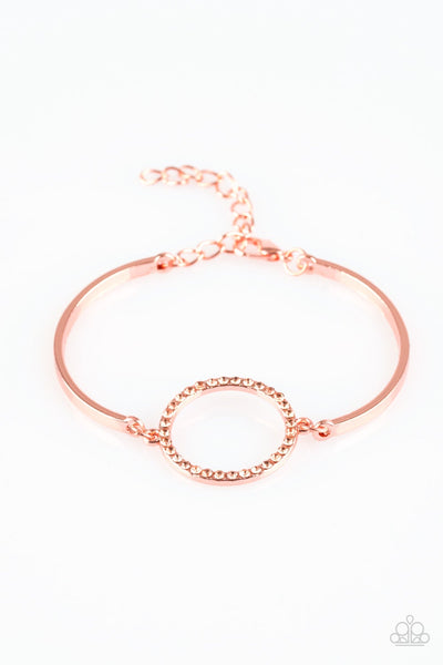 Encrusted in glittery peach rhinestones, a circular frame attaches to two shiny copper bars, creating a refined centerpiece. Features an adjustable clasp closure. Sold as one individual bracelet.  P9RE-CPSH-087XX
