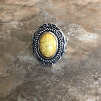 A sunny yellow stone is pressed into an antiqued silver frame radiating with floral detail for a seasonal look. Features a stretchy band for a flexible fit. Sold as one individual ring.  P4SE-YWXX-060XX