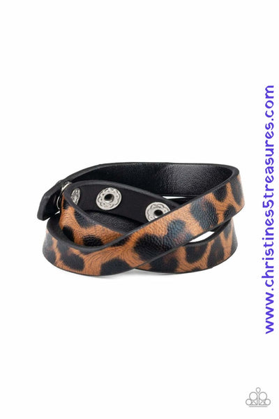 Featuring a brown and black cheetah pattern, a strip of black leather double wraps around the wrist for a wild look. Features an adjustable snap closure. Sold as one individual bracelet. P9SE-URBN-161XX