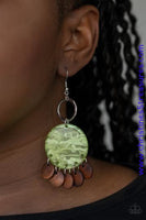 Brown wooden discs dangle from the bottom of a green acrylic frame that attaches to a shimmery silver ring, creating a beach inspired look. Earring attaches to a standard fishhook fitting. Sold as one pair of earrings.  P5SE-GRXX-081XX