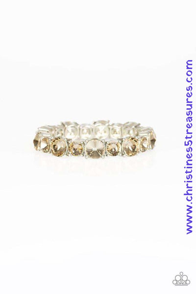 An assortment of oversized golden topaz rhinestones are pressed into sleek square frames and threaded along stretchy bands, creating a blinding sparkle around the wrist. Sold as one individual bracelet. P9RE-BNXX-126XX