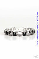 An assortment of over sized black and hematite rhinestones are pressed into sleek square frames and threaded along stretchy bands, creating a blinding sparkle around the wrist. Sold as one individual bracelet. P9RE-MTXX-075XX