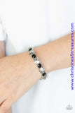 An assortment of over sized black and hematite rhinestones are pressed into sleek square frames and threaded along stretchy bands, creating a blinding sparkle around the wrist. Sold as one individual bracelet. P9RE-MTXX-075XX