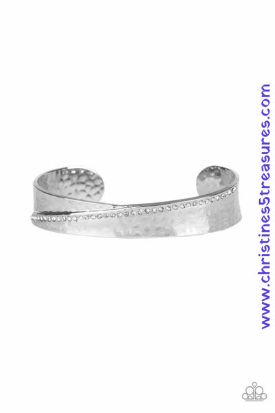 A row of glassy white rhinestones slants across the front of a hammered silver cuff for a refined look. Sold as one individual bracelet.  P9RE-WTXX-316XX
