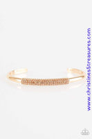 The center of a dainty gold cuff is encrusted in row after row of glassy peach rhinestones for a timeless look. Sold as one individual bracelet. P9RE-GDXX-153XX