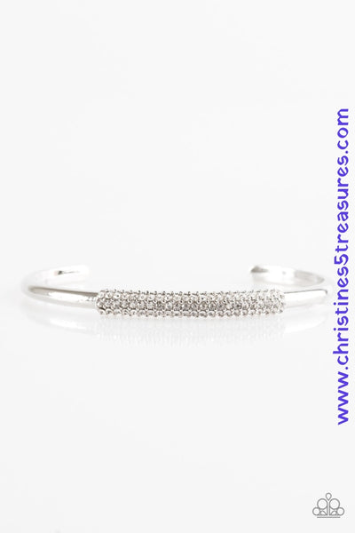 The center of a dainty silver cuff is encrusted in row after row of glassy white rhinestones for a timeless look. Sold as one individual bracelet. P9RE-WTXX-189XX