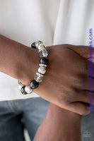 Oversized silver, smoky crystal-like, and polished black beads are threaded along a stretchy elastic band and wrapped around the wrist for a glamorous look. White rhinestone encrusted rings are sprinkled between the dramatic beads for a sparkling finish. Sold as one individual bracelet. Get The Complete Look! Necklace: "The Camera Never Lies - Black" (Sold Separately) P9RE-BKXX-212GH