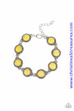 Smooth yellow stones are pressed into studded silver frames and linked around the wrist for a seasonal flair. Features an adjustable clasp closure. Sold as one individual bracelet. P9SE-YWXX-091XX