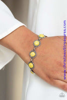 Smooth yellow stones are pressed into studded silver frames and linked around the wrist for a seasonal flair. Features an adjustable clasp closure. Sold as one individual bracelet. P9SE-YWXX-091XX