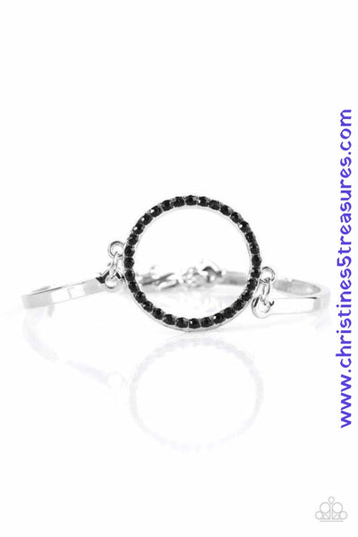 Encrusted in glittery black rhinestones, a circular frame attaches to two silver bars, creating a refined centerpiece. Features an adjustable clasp closure. Sold as one individual bracelet.  P9DA-BKXX-087XX