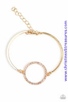 Encrusted in glittery white rhinestones, a circular frame attaches to two gold bars, creating a refined centerpiece. Features an adjustable clasp closure. Sold as one individual bracelet.  P9DA-GDXX-135XX