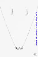 Shimmery silver accents and glittery white rhinestones join into a dainty frame, creating a bubbly pendant below the collar for a timeless look. Features an adjustable clasp closure. Sold as one individual necklace. Includes one pair of matching earrings. P2DA-WTXX-135XX