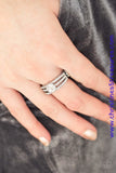 Encrusted in dainty white rhinestones, glistening silver bars layer across the finger, coalescing into a gorgeous band. A glittery white rhinestone is pressed into the center of the bands, creating a refined centerpiece. Features a dainty stretchy band for a flexible fit. Sold as one individual ring.  P4RE-WTXX-238XX