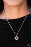 Encrusted in fiery red rhinestones, a shimmery silver heart pendant swings below the collar in a whimsical fashion. Features an adjustable clasp closure. Sold as one individual necklace. Includes one pair of matching earrings.  P2RE-RDXX-084XX