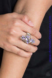 Featuring shiny purple and textured silver petals, colorful flowers dance across the finger, coalescing into a whimsical frame atop the finger. Features a stretchy band for a flexible fit. Sold as one individual Paparazzi ring. P4WH-PRXX-158XX