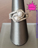 2020 March Fashion Fix Exclusive Glittery white rhinestone encrusted bands swirl around a pair of silver pearls for a refined look. Features a dainty stretchy band for a flexible fit. Sold as one individual ring. P4RE-SVXX-137XX