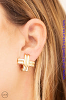 Glistening gold bars crisscross over one another, coalescing into an edgy frame. Earring attaches to a standard clip-on fitting. Sold as one pair of clip-on earrings.  P5CO-GDXX-011XX