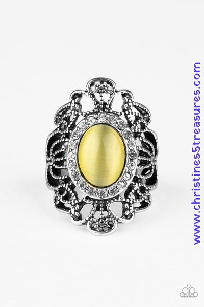 Ringed in glassy white rhinestones, a dewy yellow cat's eye stone is pressed into the center of a frilly silver frame swirling with studded filigree. Features a stretchy band for a flexible fit. Sold as one individual ring.  P4RE-YWXX-049XX