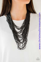 Brushed in an icy metallic shimmer, countless strands of gunmetal seed beads drape across the chest in a bold fashion. Featuring a collision of shapes and shimmer, the glittery strands connect to two large gunmetal accents for a flashy finish. Features an adjustable clasp closure. Sold as one individual necklace. Includes one pair of matching earrings.  P2SE-BKXX-219XX