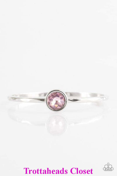 A faceted pink gem is pressed into the center of a shimmery silver bangle, creating a dramatic centerpiece atop the wrist.  P9RE-PKXX-114XX