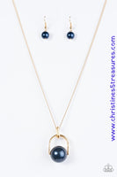 Brushed in a pearlescent shimmer, an oversized blue bead is pinched between a glistening gold frame, creating the illusion of a floating pearl for a dramatic look. Features an adjustable clasp closure. Sold as one individual necklace. Includes one pair of matching earrings.  P2RE-BLGD-123XX