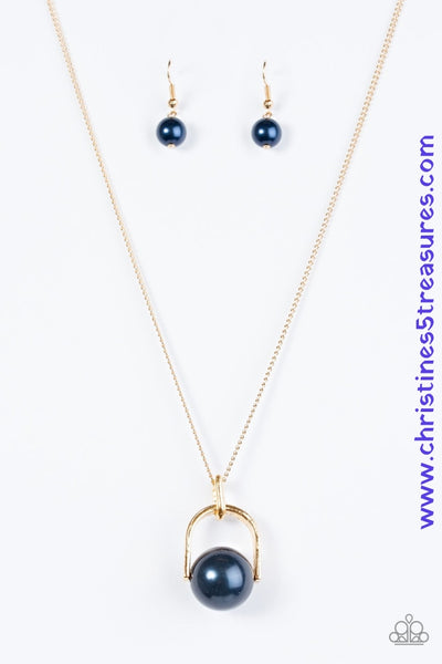 Brushed in a pearlescent shimmer, an oversized blue bead is pinched between a glistening gold frame, creating the illusion of a floating pearl for a dramatic look. Features an adjustable clasp closure. Sold as one individual necklace. Includes one pair of matching earrings.  P2RE-BLGD-123XX