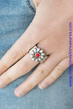 Brushed in an antiqued finish, a glistening silver flower blooms from the center of a thick silver band for a whimsical look. Featuring a faceted surface, a dainty red bead dots the center of the flower for a colorful finish. Features a stretchy band for a flexible fit.  P4WH-RDXX-160XX