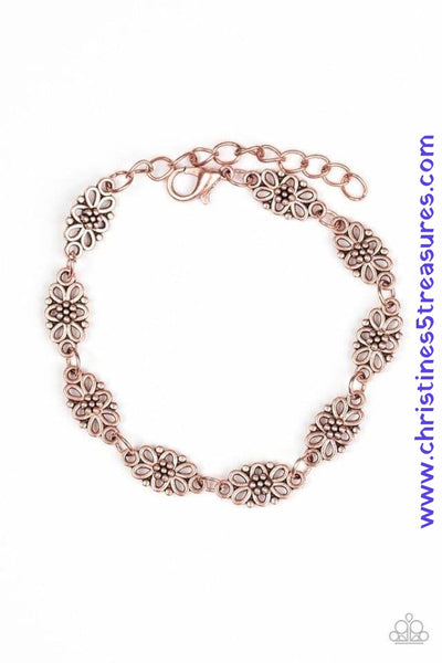 Brushed in an antiqued shimmer, dainty floral charms link across the wrist for a seasonal look. Features an adjustable clasp closure. Sold as one individual bracelet.  Get The Complete Look! Necklace: "Daisy Dream - Copper" (Sold Separately)  P9WH-CPXX-102VZ