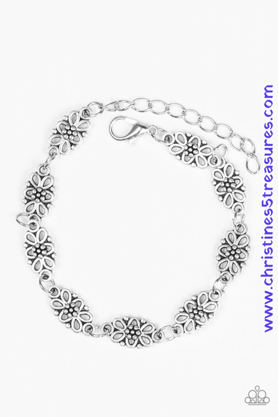 Brushed in an antiqued shimmer, dainty floral charms link across the wrist for a seasonal look. Features an adjustable clasp closure. Sold as one individual bracelet.  Get The Complete Look! Necklace: "Daisy Dream - Silver" (Sold Separately)  P9WH-SVXX-147WA