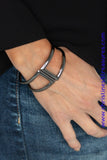 Brushed in a high-sheen shimmer, geometric gunmetal frames curl around the wrist, creating a tribal inspired cuff. Features a hinged closure. Sold as one individual bracelet.  P9SE-BKXX-182XX