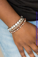 Mismatched silver and pearly brown beads are threaded along stretchy elastic bands, creating colorful layers across the wrist. Sold as one set of three bracelets.   P9RE-BNXX-091XX