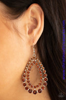 Varying in size, rows of glittery topaz rhinestones coalesce into two blinding teardrops for a jaw-dropping dazzle. Earring attaches to a standard fishhook fitting. Sold as one pair of earrings.  P5RE-BNXX-097XX