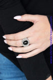 A shiny black bead is pressed into the center of a bold silver band radiating with countless white rhinestones, creating a dramatic statement piece atop the finger. Features a stretchy band for a flexible fit. Sold as one individual ring.  P4RE-BKXX-199XX
